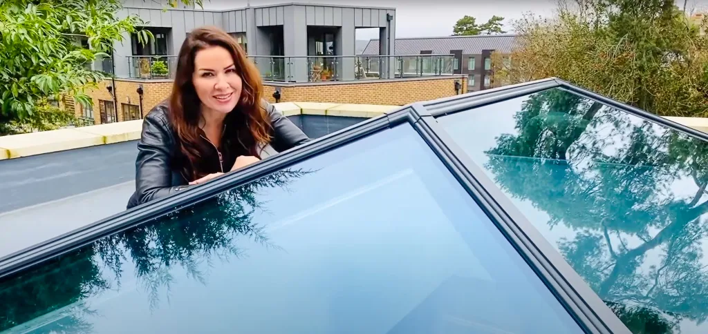 Georgina Burnett, "The Home Genie," sitting on a roof with the Korniche Roof Lantern