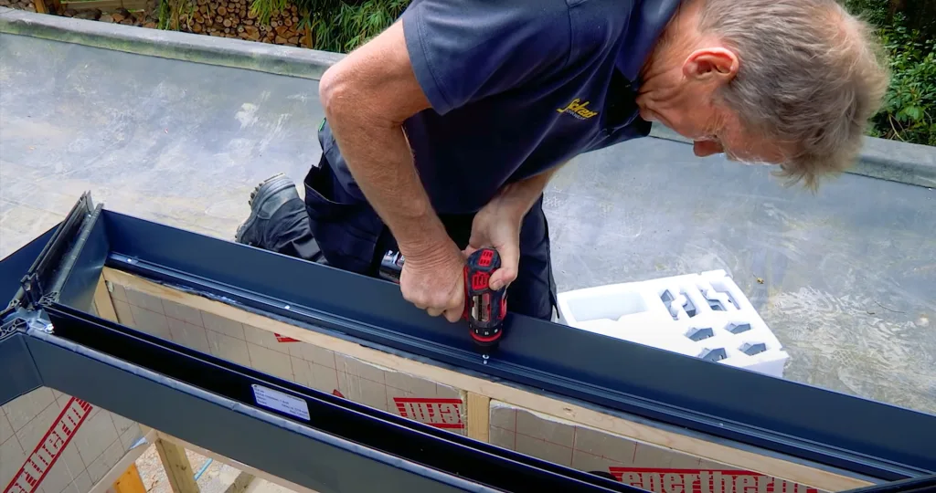 Roger Bisby installing a Korniche Roof Lantern on the roof, securing it.