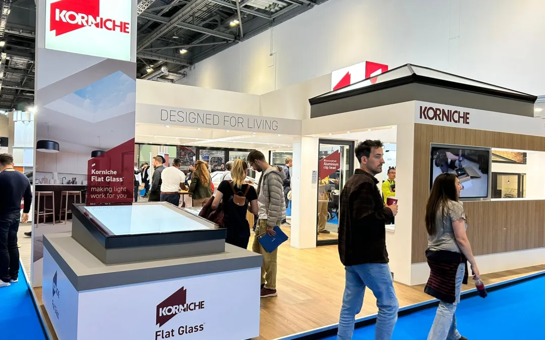 Attendees gathered around the Korniche stand, viewing product displays and interacting with company representatives.