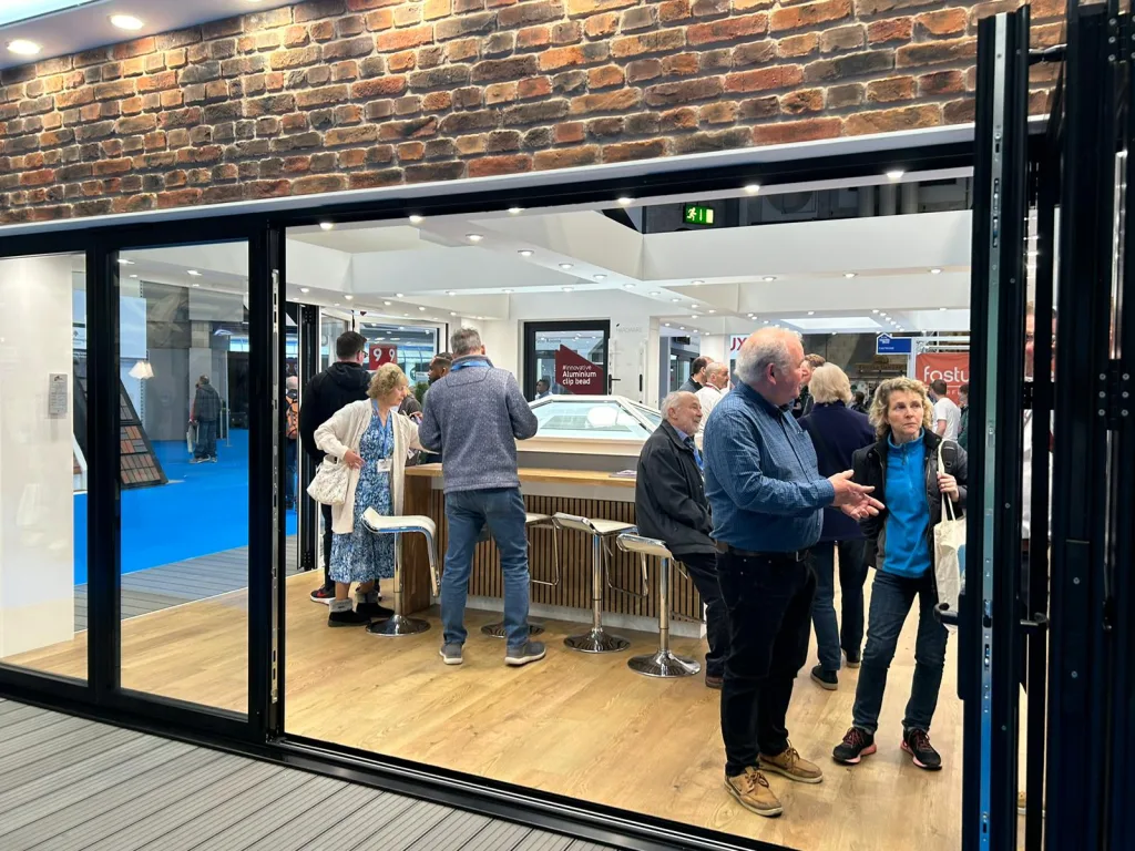 Attendees at the National Homebuilding & Renovating Show chat with the friendly Korniche team while examining a roof lantern.