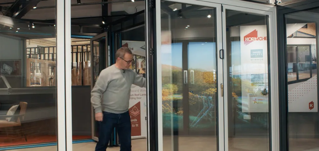 Korniche Brand Ambassador Mark Millar demonstrates the smooth operation of Korniche Bi-Folding Doors.