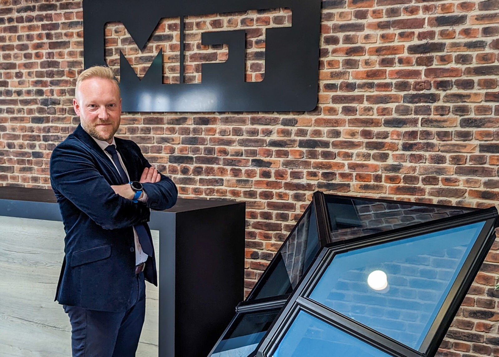 Close-up of Bradley Gaunt, Managing Director of Made For Trade, standing next to a Korniche Roof Lantern