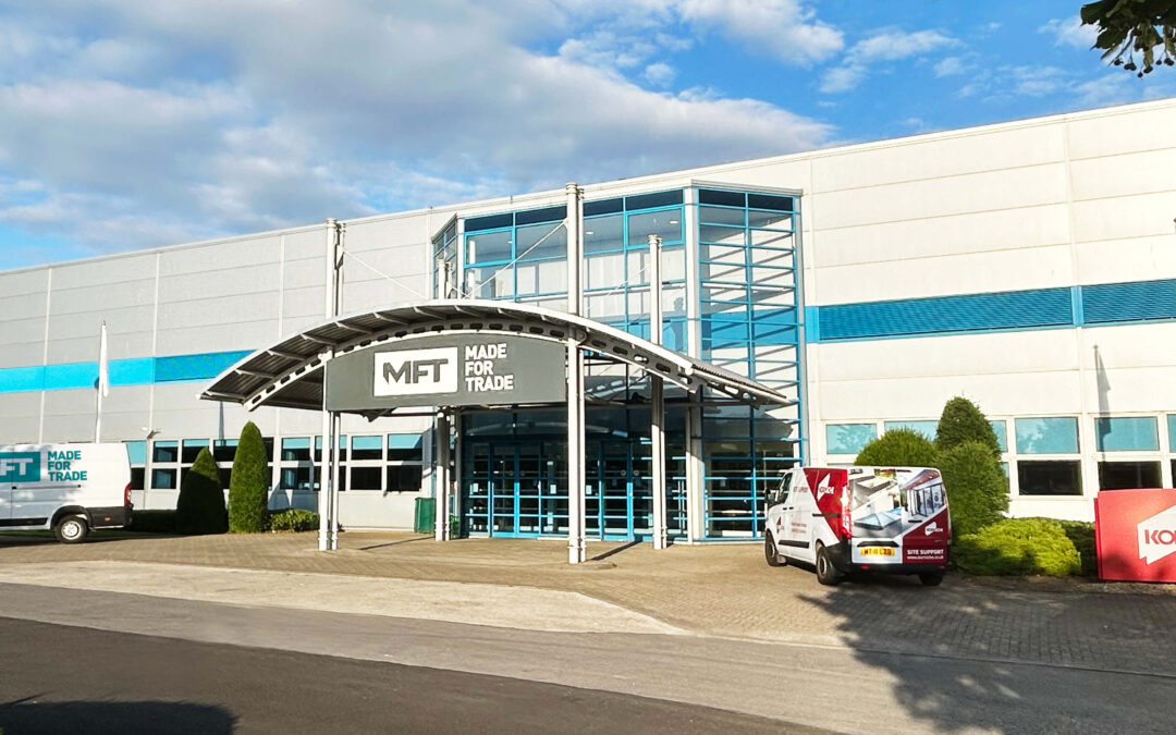 Made For Trade building on a sunny day with blue sky, featuring Made For Trade and Korniche signage and vehicles.