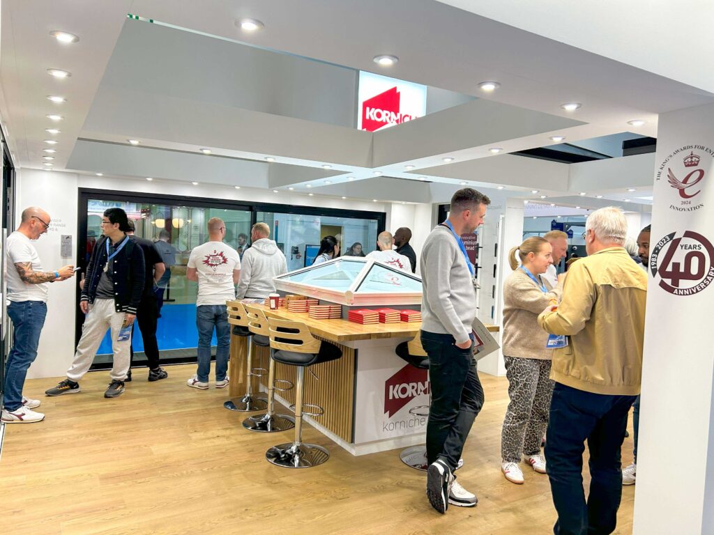 Visitors admiring Korniche Roof Lantern and Flat Glass Rooflight at the London Homebuilding & Renovating Show.